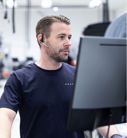 Volvo technician taking a call at a workstation
